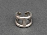 a close up of a silver ring on a gray surface