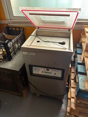 a machine that is sitting next to a pile of crates