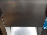 a stainless steel dishwasher that is on the ground