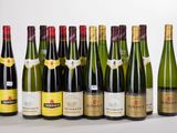 several bottles of wine are lined up on a white surface