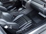 the interior of a sports car with black leather seats and a center console