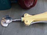 a yellow handle that is attached to a metal object