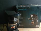 an image of a coffee maker sitting on top of a wooden table
