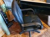 a desk with a chair and a computer on it