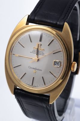 an image of a close up of a wrist watch with a gold case