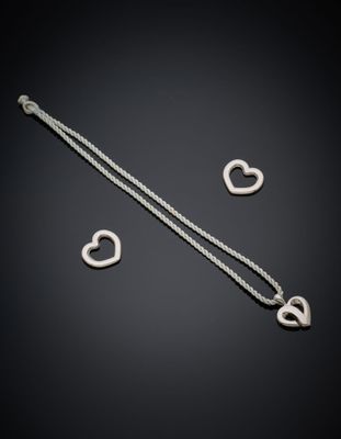 a silver necklace with two heart charms on a black background