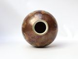 a vase that is sitting on a white surface