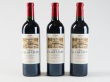 three bottles of red wine sitting next to each other on a white surface