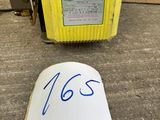 an image of a piece of paper sitting on the ground next to a yellow box
