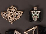 several pieces of jewelry are displayed on a black surface