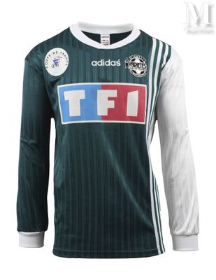 a close up of a green and white soccer jersey with a red, white, and blue stripe