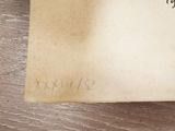 an old book with writing on it sitting on a table