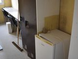 an image of a room with a refrigerator and a desk