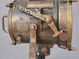 an old machine that is sitting on a stand