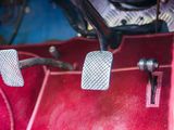 a close up of a car ' s pedals and steering controls