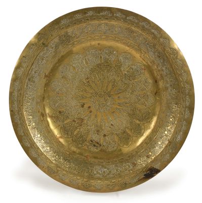 an image of a gold plate with a circular design on it
