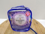 a clear bag with a blue handle sitting on a wooden table
