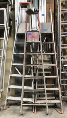 many different types of ladders in a garage
