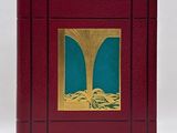 a red book with a picture of a tree on it