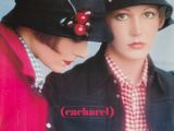 two people that are wearing hats with cherries on them