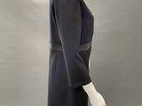 an image of a mannequin wearing a black dress and hat