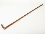 an old wooden stick with a long handle on a white surface