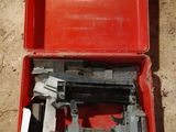 a red box with a stapler and a stapler in it