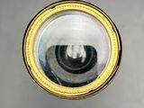 an image of a close up of a mirror with a reflection of a person in it