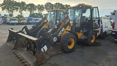a picture of a backhoe and a loader in a parking lot
