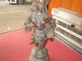 a statue of a woman holding a baby on a red surface