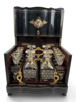 an image of a black and gold decorated chest of liquor glasses