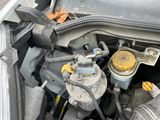 a close up of a car ' s engine with its hood open