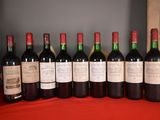several bottles of wine are lined up on a table