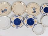 many plates that are sitting on a white table