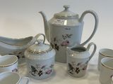 a lot of cups and saucers sitting on a table
