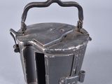 a small metal container with a handle on it