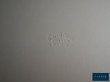 a close up of a white wall with a small imprint on it