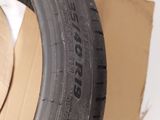 two tires sitting on top of a cardboard box next to a cardboard box
