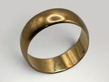 a close up of a gold ring on a white surface