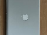 a white apple laptop sitting on a wooden table