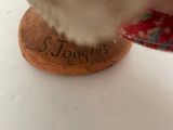 a person cutting a piece of wood with a knife