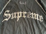 the back of a black shirt with the word supreme written on it