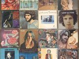 an image of a collection of various album covers on a table