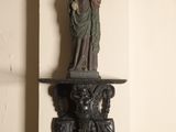 a statue of a woman holding a child on a shelf