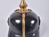 a black and gold helmet with a gold spiked top