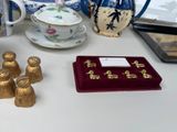 a white table with a bunch of gold figurines on it