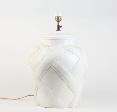 a white lamp that is on a white table