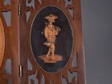 pair of carved wood frames with a picture of a man and woman on them