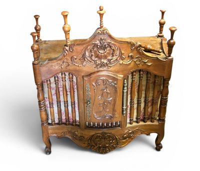 a wooden crib with a book shelf on top of it