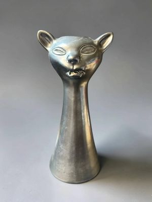 an image of a silver cat head vase on a white surface